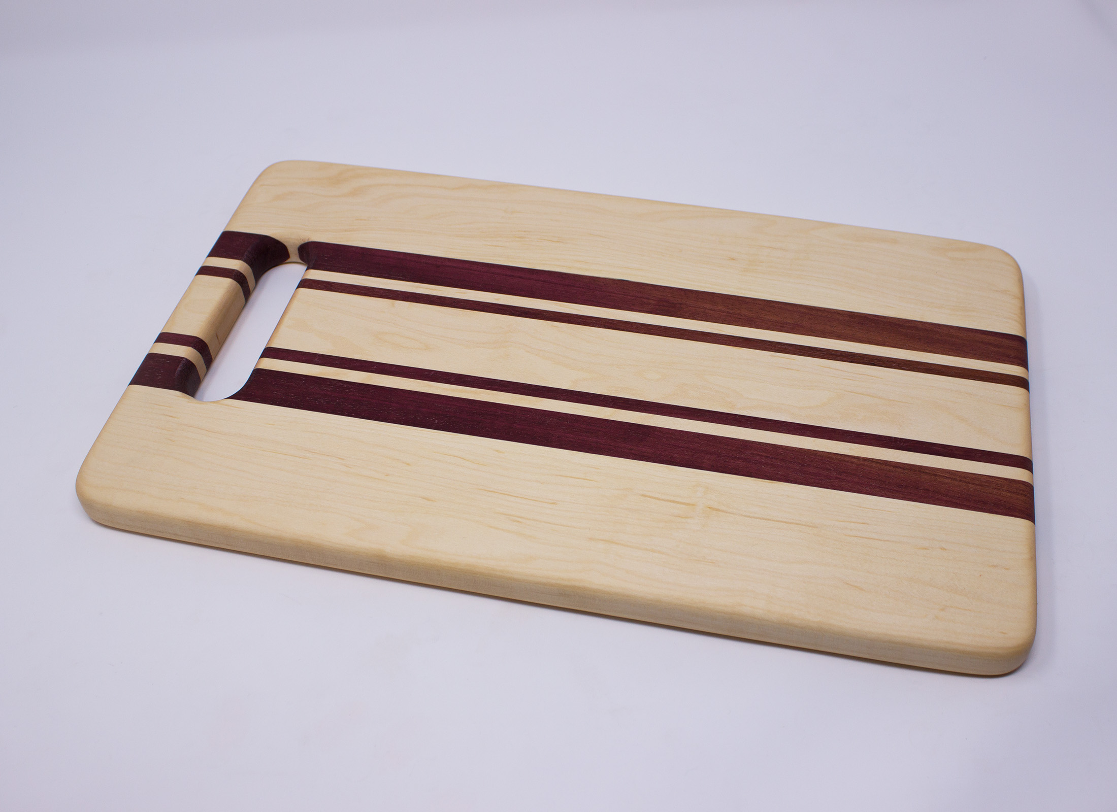 Montana Made Cutting Board with Handle in Walnut, Purpleheart and