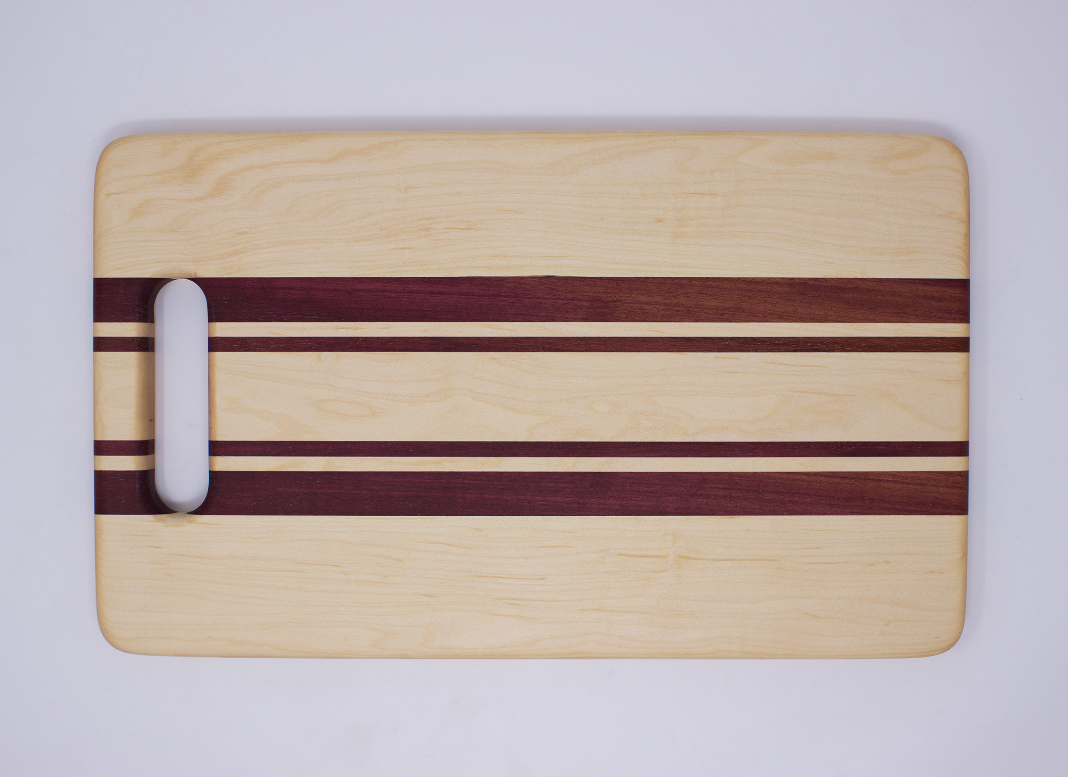 Montana Made Cutting Board with Handle in Walnut, Purpleheart and