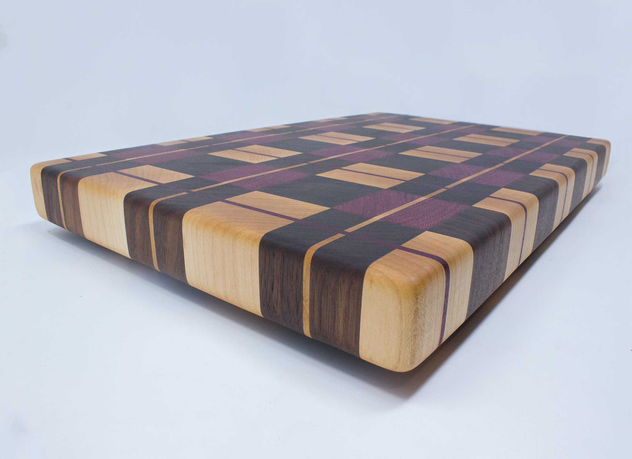 https://www.rockfordwoodcrafts.com/wp-content/uploads/Purple-Plaid-End-Graing-Cutting-Board-Angled-Close-Up.jpg